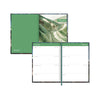 Green planner with a scenic cover and open to a calendar page.