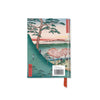 Notebook with a scenic Japanese design of Mount Fuji on the cover, featuring trees and people, on a white background.