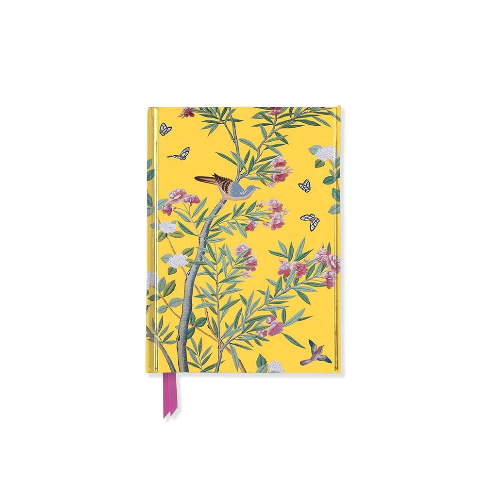 Notebook with floral and bird design on a yellow background
