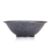 Side view. The Seikaiha Japanese Ramen Noodle Bowl is an authentic Japanese noodle bowl with a very stylish blue and white design on the inside and a mottled charcoal grey and black on the outside.