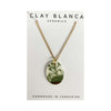 Necklace with a floral pendant on a Clay Blanca Ceramics card