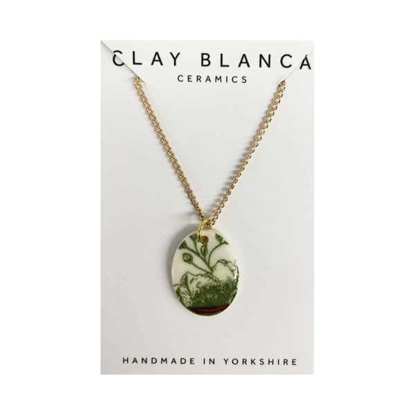 Necklace with a floral pendant on a Clay Blanca Ceramics card