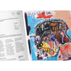 An open art book showing a colourful abstract portrait painting from Jean-Michel Basquiat on the right page and printed text on the left page.