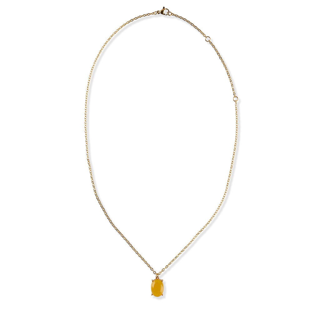 Gold necklace with a yellow gemstone pendant on a white background