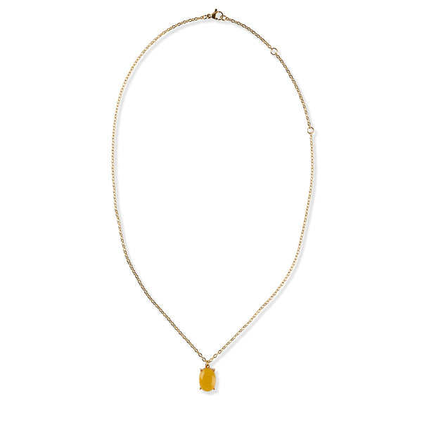 Gold necklace with a yellow gemstone pendant on a white background
