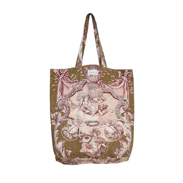 A canvas tote bag featuring a vintage-style toile de Jouy print with pink cherubs and scrollwork on an olive green background, set against a plain white studio background.
