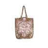 A canvas tote bag featuring a vintage-style toile de Jouy print with pink cherubs and scrollwork on an olive green background, set against a plain white studio background.