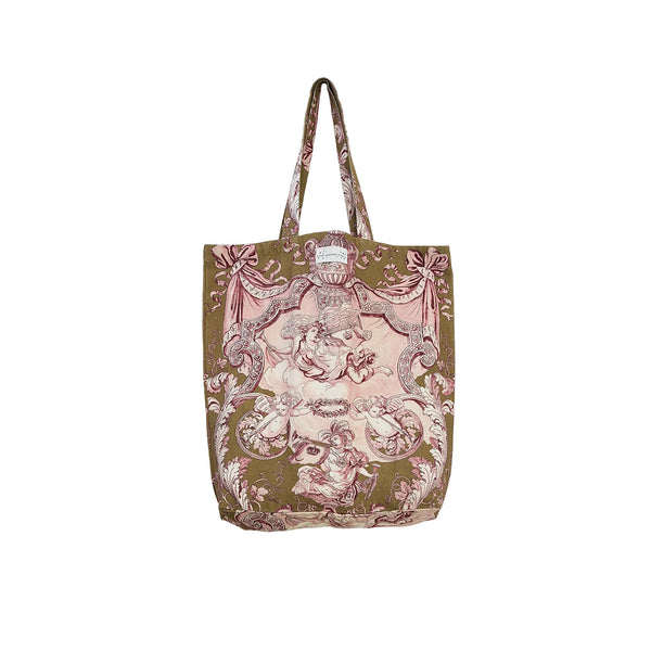 A canvas tote bag featuring a vintage-style toile de Jouy print with pink cherubs and scrollwork on an olive green background, set against a plain white studio background.