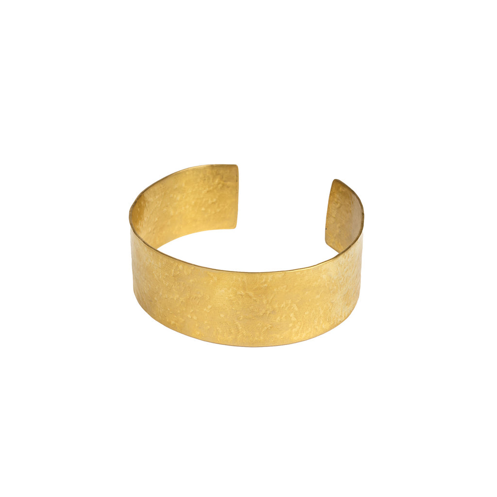 A textured gold cuff bracelet on a solid white background.