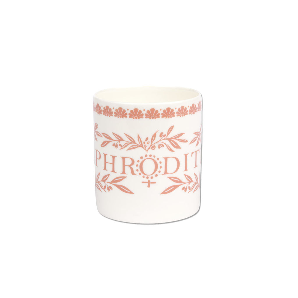 A white ceramic mug featuring a terracotta pink printed design with the word 'PHRODIT' and floral/leaf motifs, set against a plain white background.