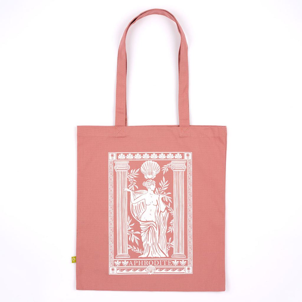 A dusty rose canvas tote bag with a white graphic print of the goddess Aphrodite on the front, displayed flat against a solid white background.