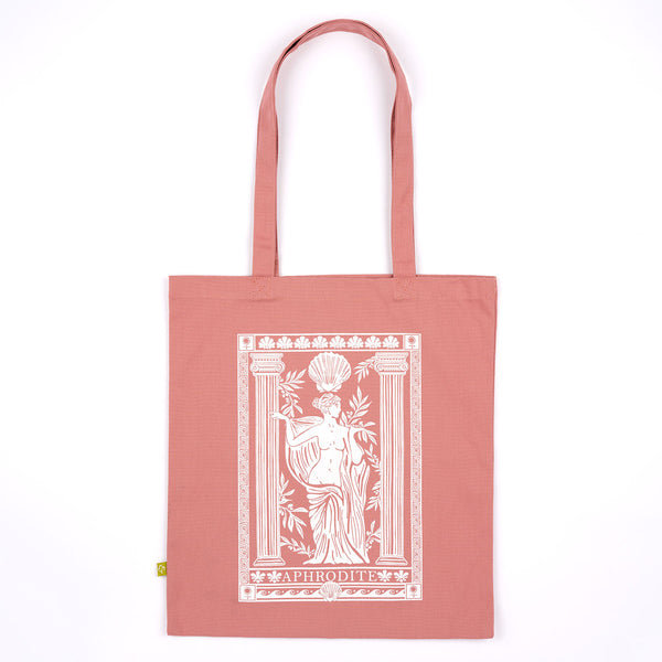 A dusty rose canvas tote bag with a white graphic print of the goddess Aphrodite on the front, displayed flat against a solid white background.