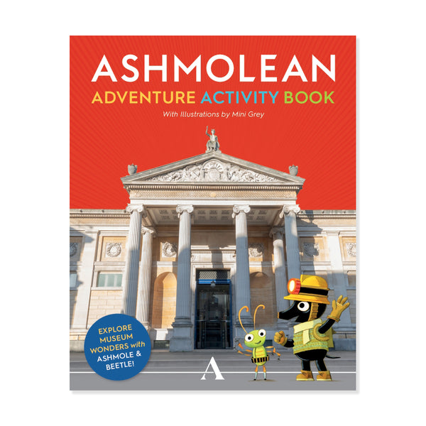 Front cover of the Ashmolean Adventure Activity Book, featuring a bright red top section with the title in large white and yellow text, a photograph of the Ashmolean museum building, and two cartoon characters in front on a white background.