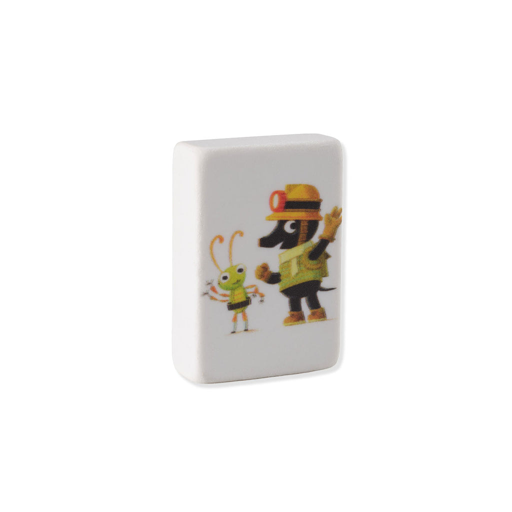A white rectangular rubber eraser featuring a colourful cartoon illustration of a black mole in a yellow construction hat next to a green insect character, shown on a plain white background.