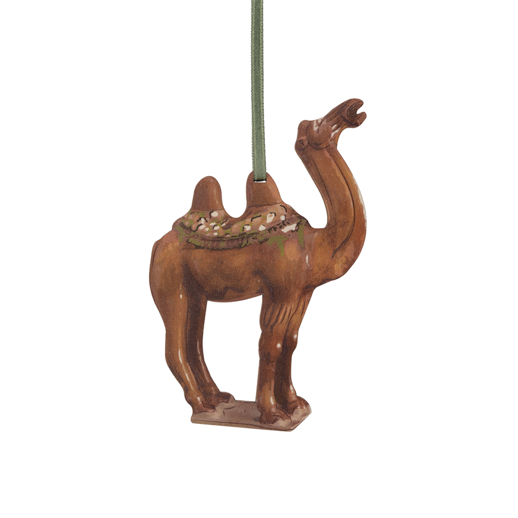 Camel-shaped wooden decoration against a white background