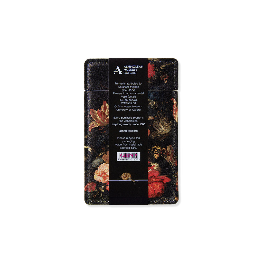 Oblong shaped pocket mirror with Dutch still life flowers artwork with bold reds oranges and pink colours with contrasting dark black backdrop against a white background.