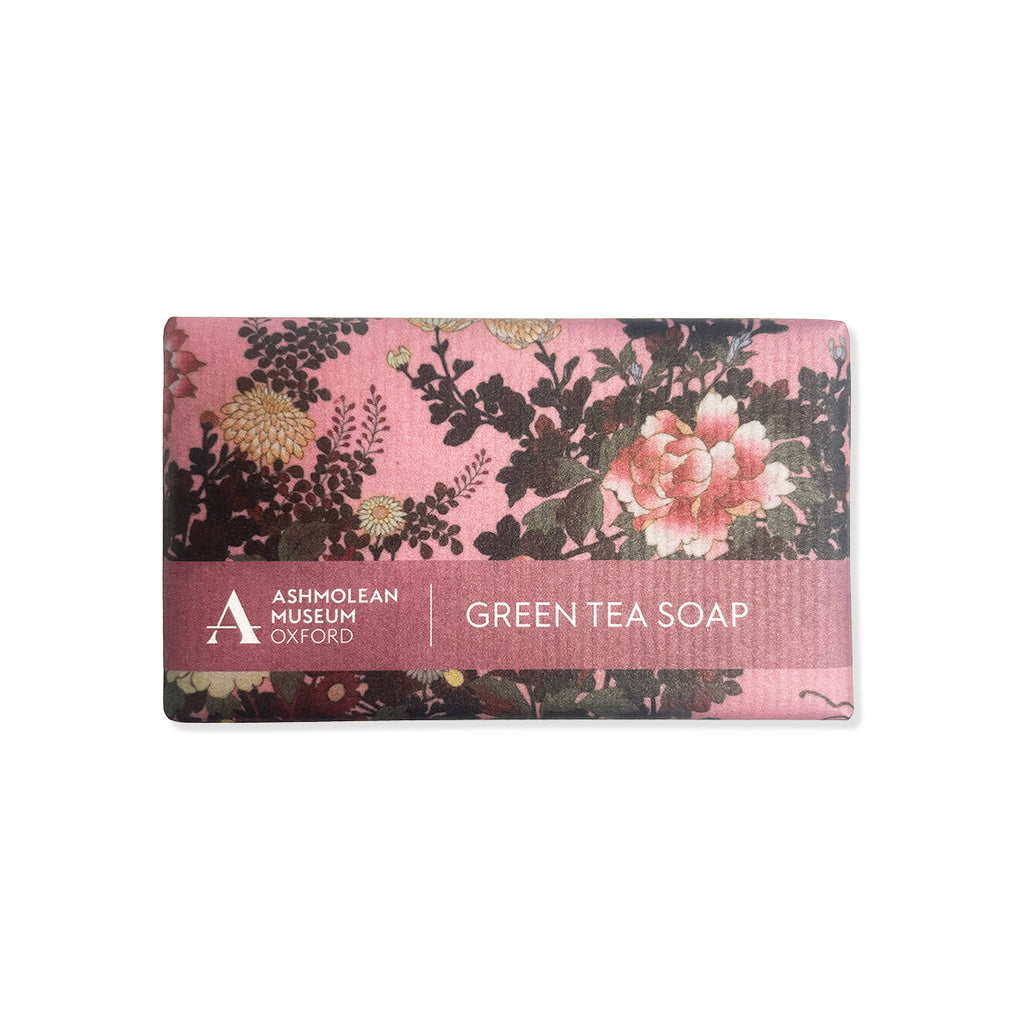 Green tea soap bar with floral design packaging on a white background