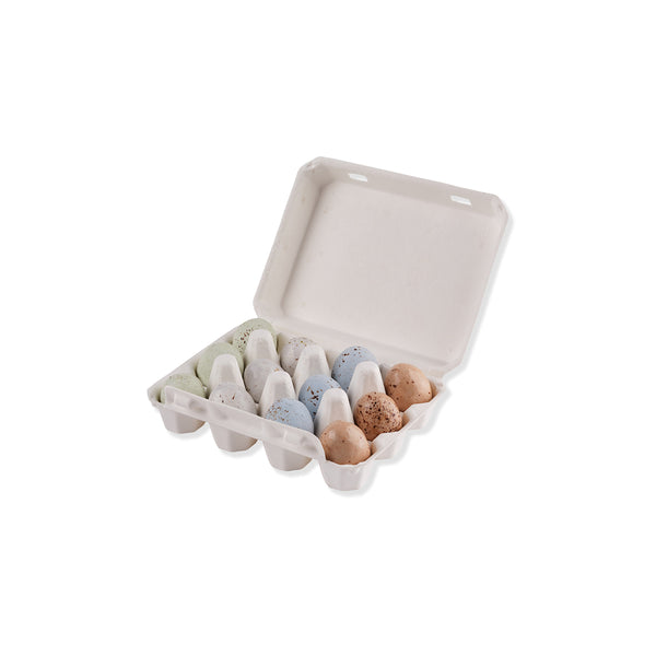 Open egg carton box with speckled green, white, blue and brown chocolate eggs on a white background.