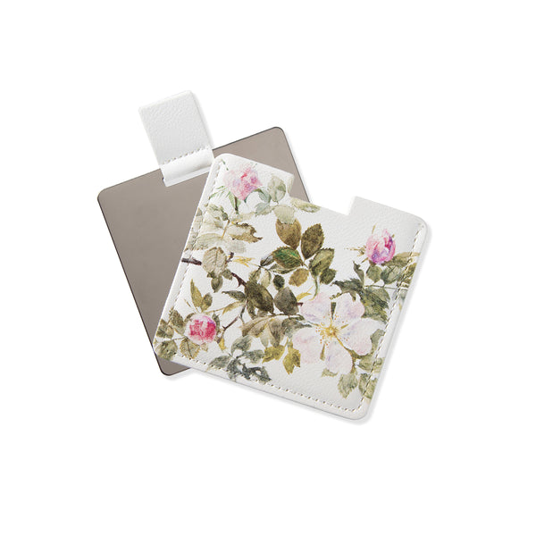 Pink floral pocket mirror with rose artwork on a white background.