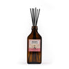 Reed diffuser with 'Peony' label on a white background