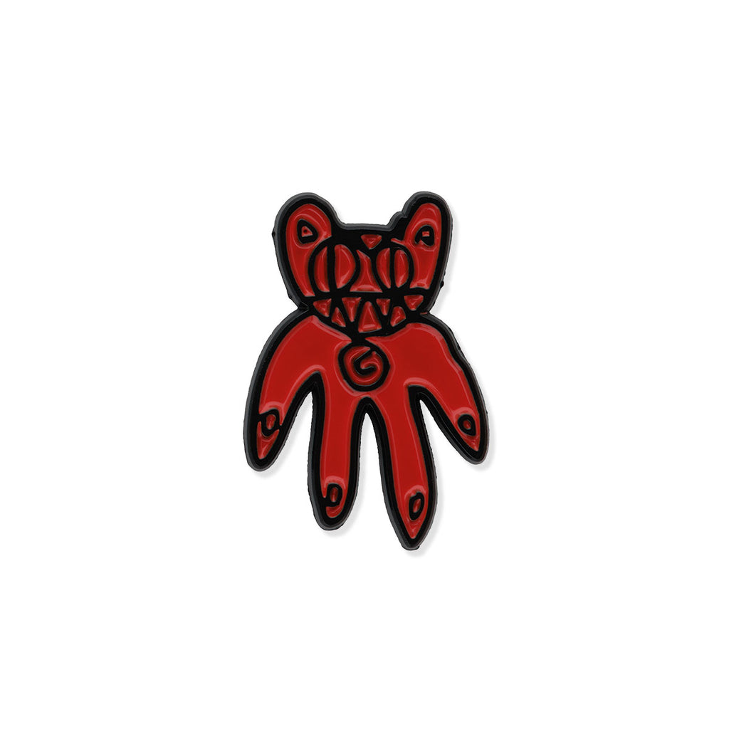 Red bear-shaped pin badge on a white background