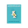 A wooden pin badge featuring a cartoon Beetle character wearing a green shirt and yellow-and-black striped tool belt, displayed on a turquoise Ashmolean branded backing card.
