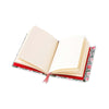 Open lined notebook with floral and red design on a white background