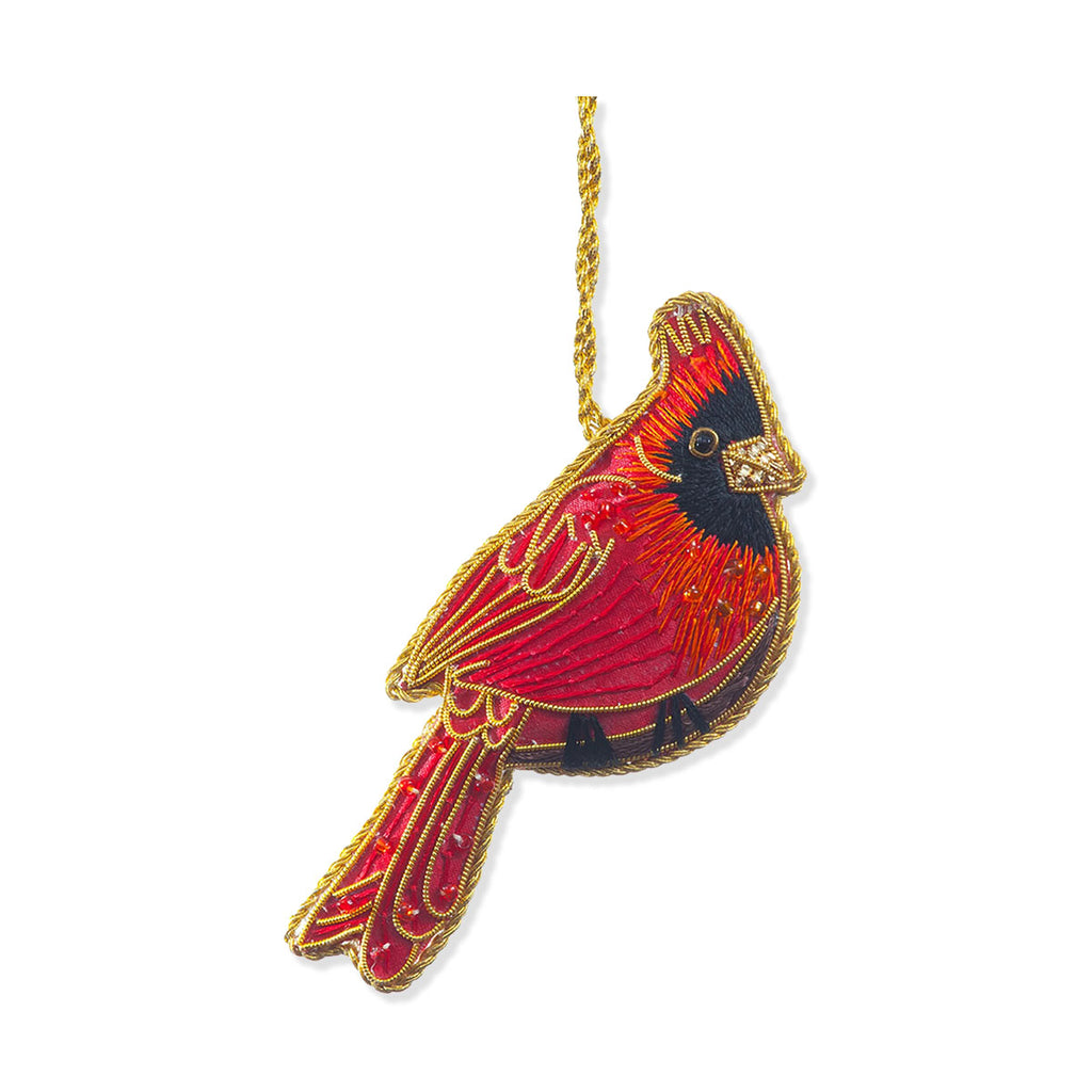 Decorative cardinal bird ornament with red and black design on a white background