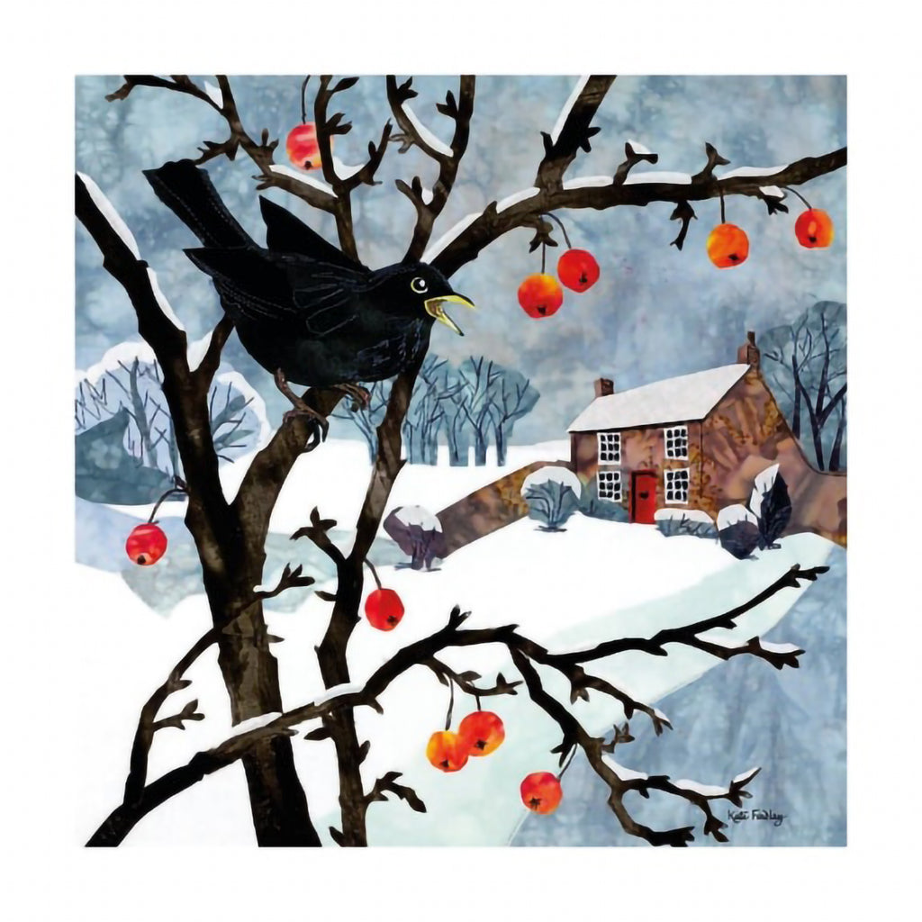 Card featuring festive artwork of blackbird perched on crab apple tree covered in snow with countryside house and fields in the background with black, white, grey, and orange colours. 