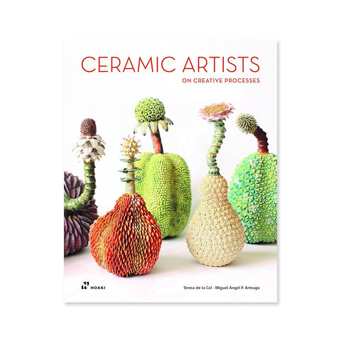 White background with five ceramic fruits, in purple, orange, green and pale yellow. This book contains a representative selection of the work of some of the best ceramic artists in the world. 