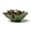 Green ceramic flower-shaped object on a white background