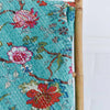 Floral patterned fabric with a bamboo stick on a white background