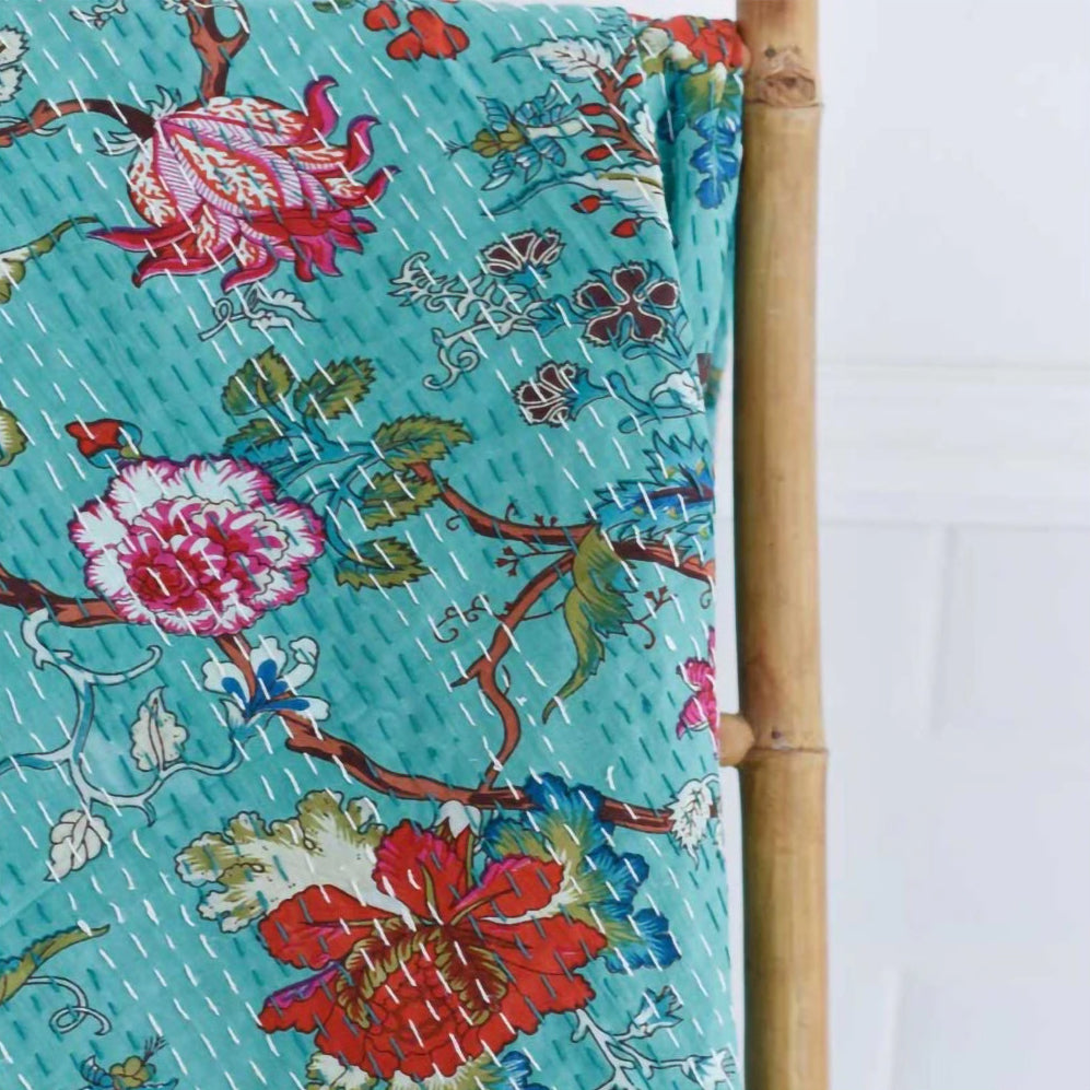 Floral patterned fabric with a bamboo stick on a white background