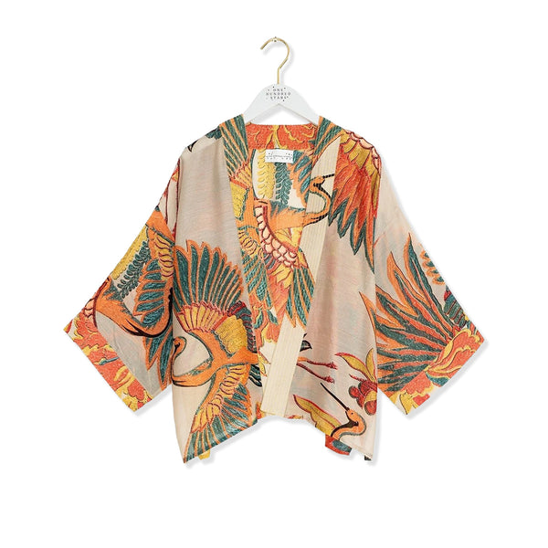 Stone Kimono with colourful Japanese cranes detailing on a white background.
