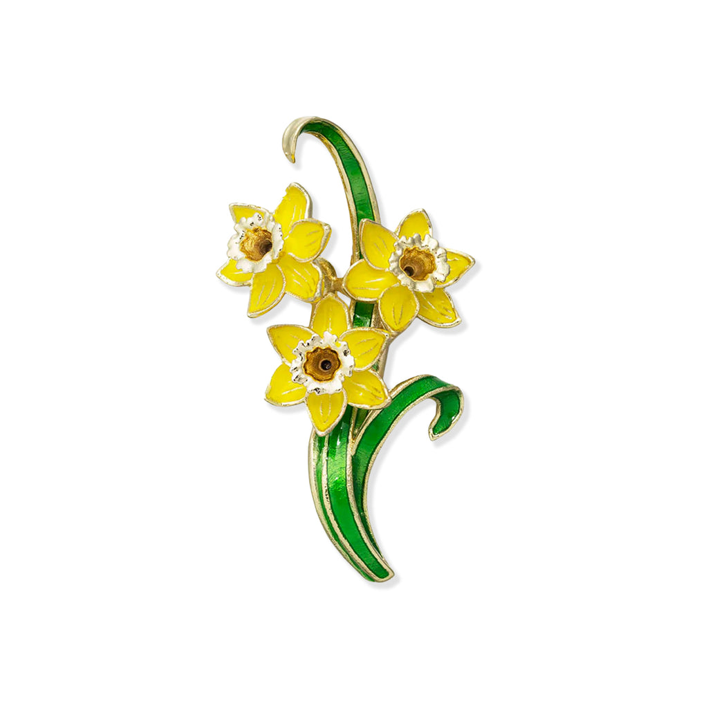 Brooch with yellow flowers and green leaves on a white background