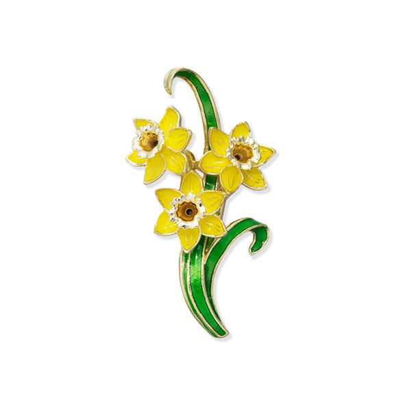 Brooch with yellow flowers and green leaves on a white background