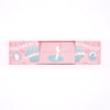 A pink rectangular chocolate box with decorative vintage-style artwork and the text 'DREAMS OF APHRODITE'.