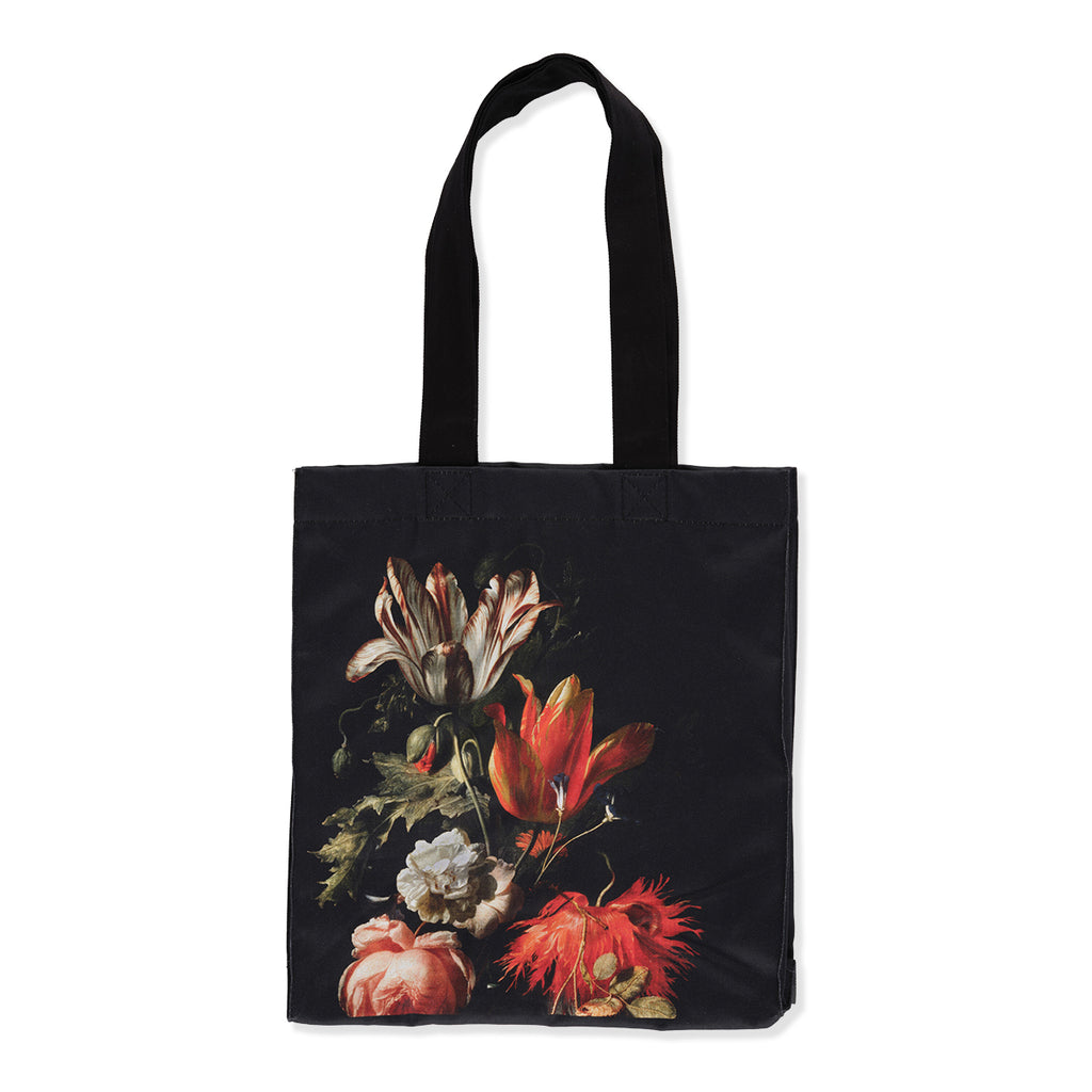 Black cotton canvas tote bag with Dutch still life flowers painting print on a white background.