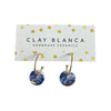 Gold hoop earrings with blue floral designs against a white background