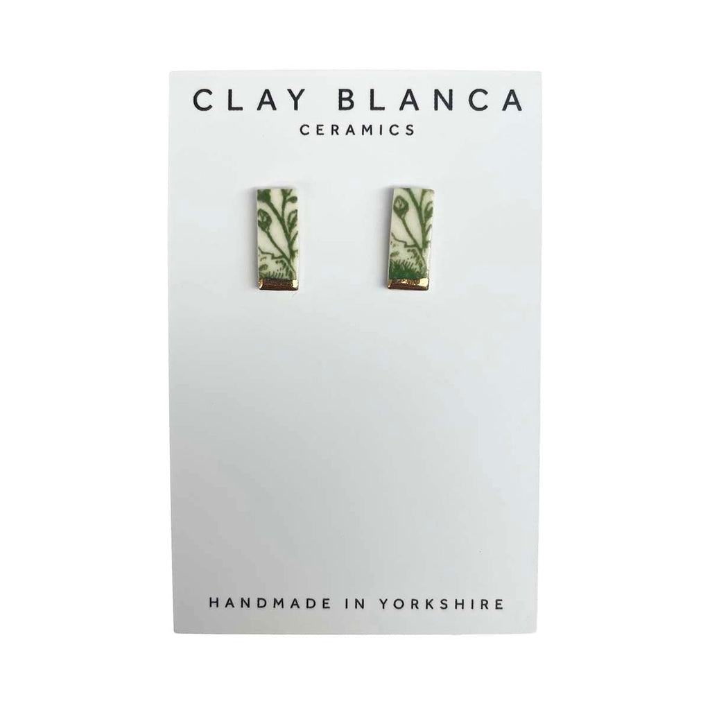 Green patterned porcelain stud earrings on a white Clay Blanca card background
