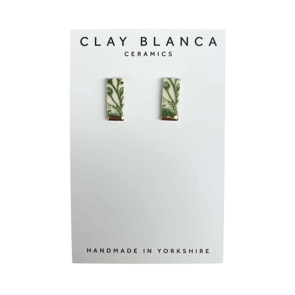 Green patterned porcelain stud earrings on a white Clay Blanca card background