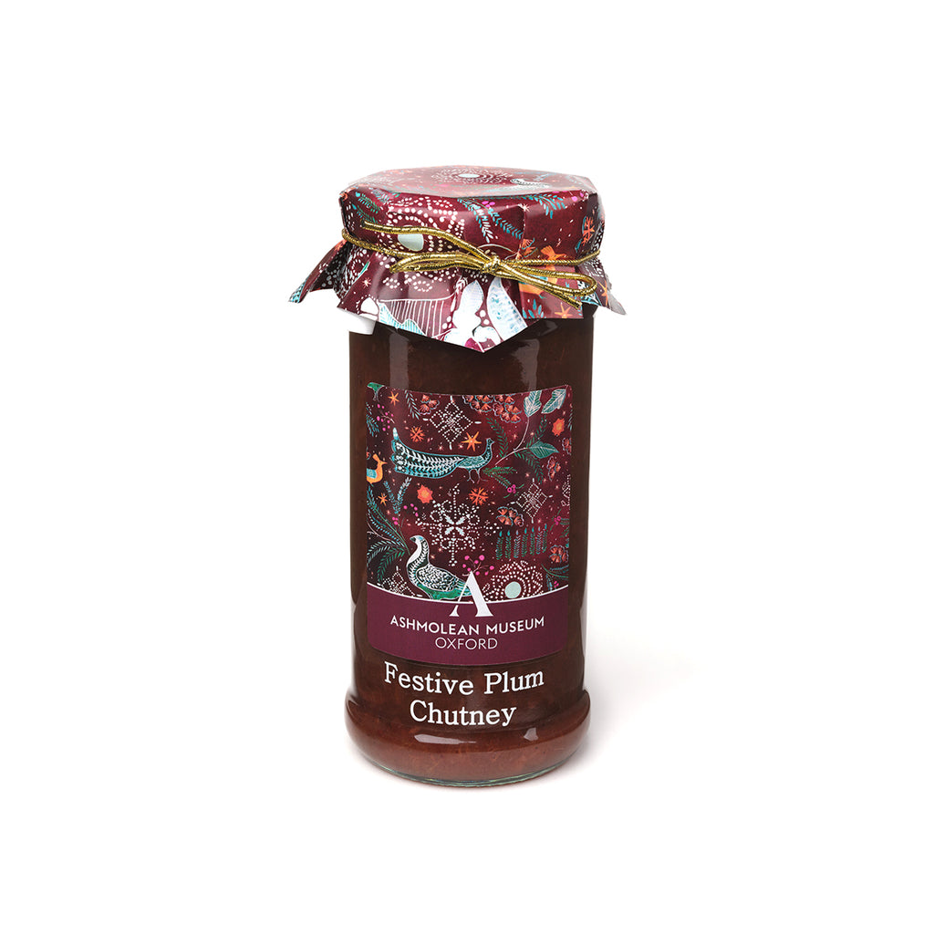 Jar of Festive Plum Chutney with decorative label against a white background