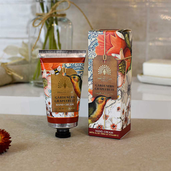 Hand cream and its packaging with a decorative design on a neutral background