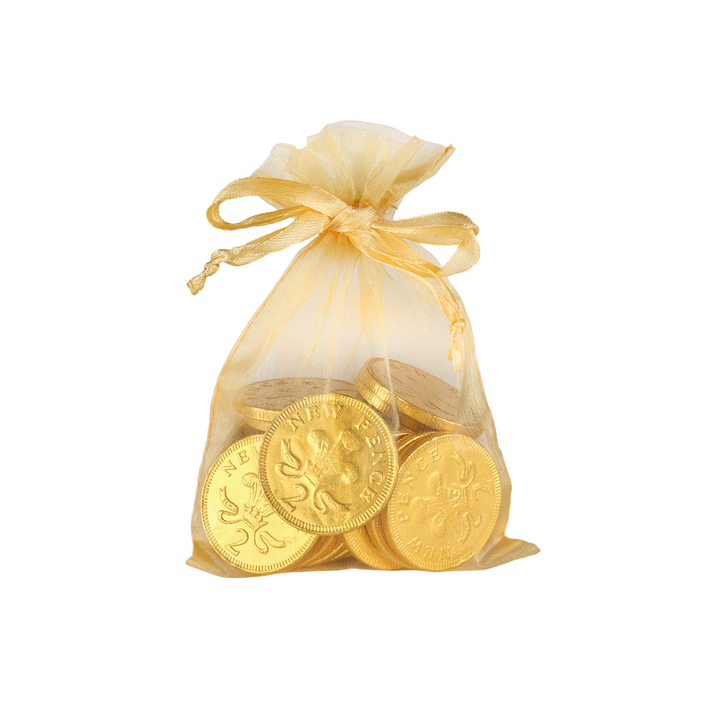 Gold chocolate coins in a drawstring bag on a white background