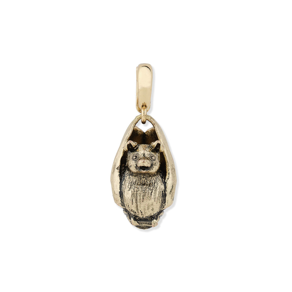Gold pendant in the shape of a bat on a white background
