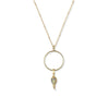 Gold necklace with a circular pendant and teardrop-shaped charm on a white background