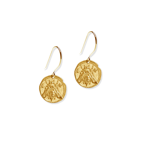 Gold bee-themed earrings on a white background