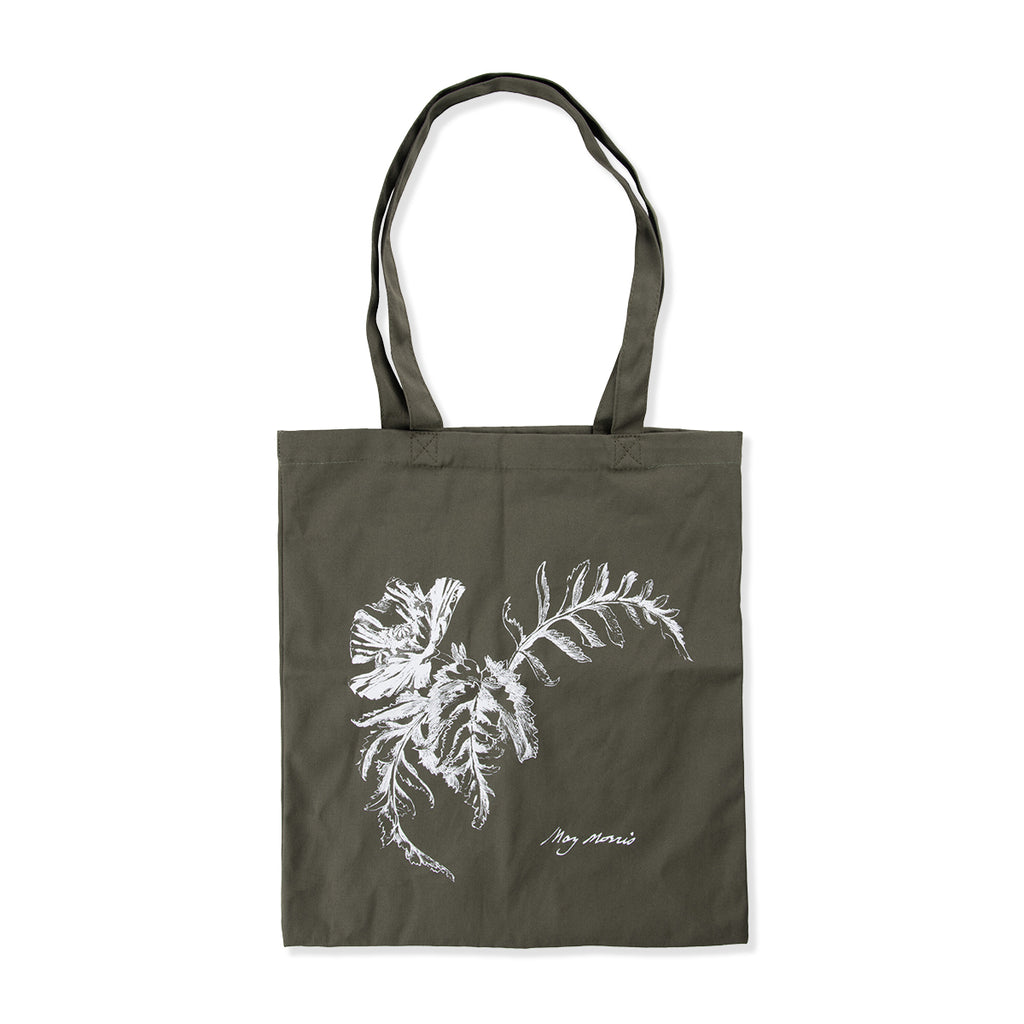 Green tote bag with a white floral design on a white background