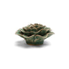 Green ceramic rose plant-shaped object on a white background
