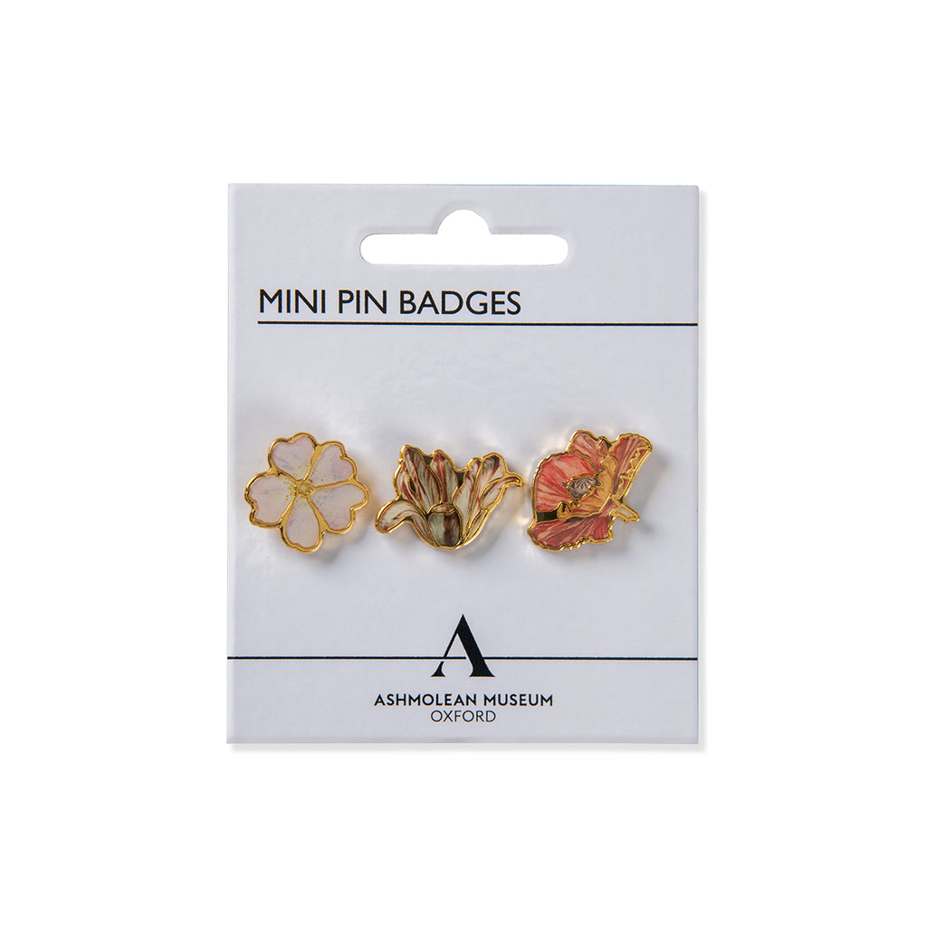 Packaged mini pin badges with floral designs on a white background, featuring the Ashmolean Museum logo.